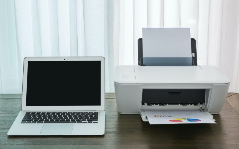 printer and Laptop on wood table